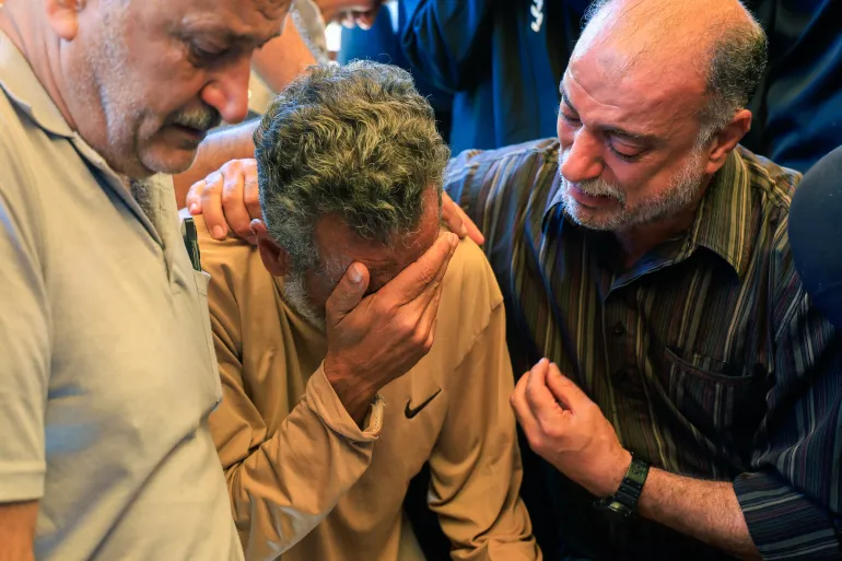 فلسطينيون يودعون أقاربهم الذين استشهدوا في غارة إسرائيلية جنوبي قطاع غزة قبل أيام (رويترز)